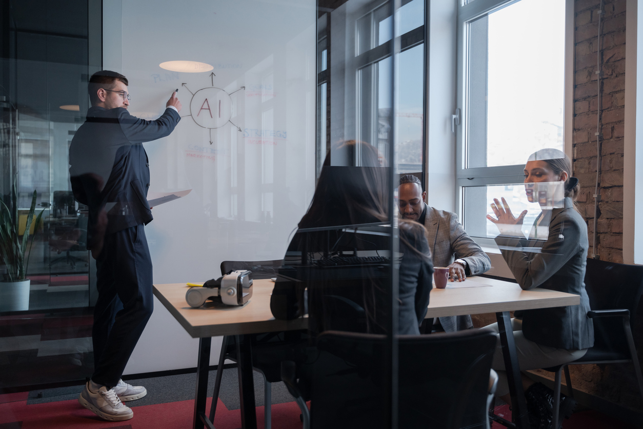 Business team discussing AI technology in a modern office. Concept of artificial intelligence in corporate strategy, innovation, and digital transformation.